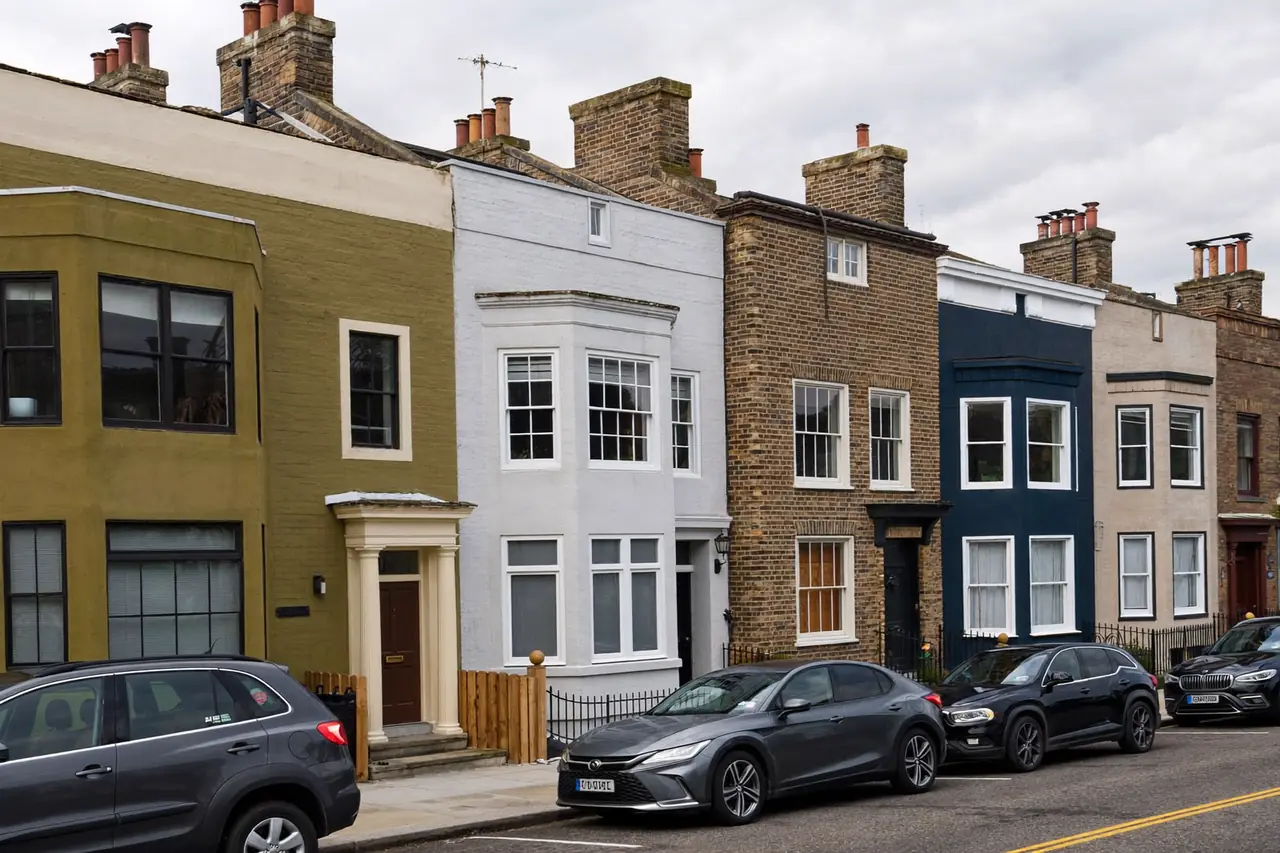 A row of brick houses with a variety of window styles